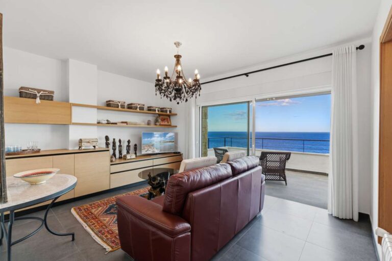 Independent living area inside a premium coastal villa on the Benissa Costa with kitchenette, sofa seating and panoramic sea views