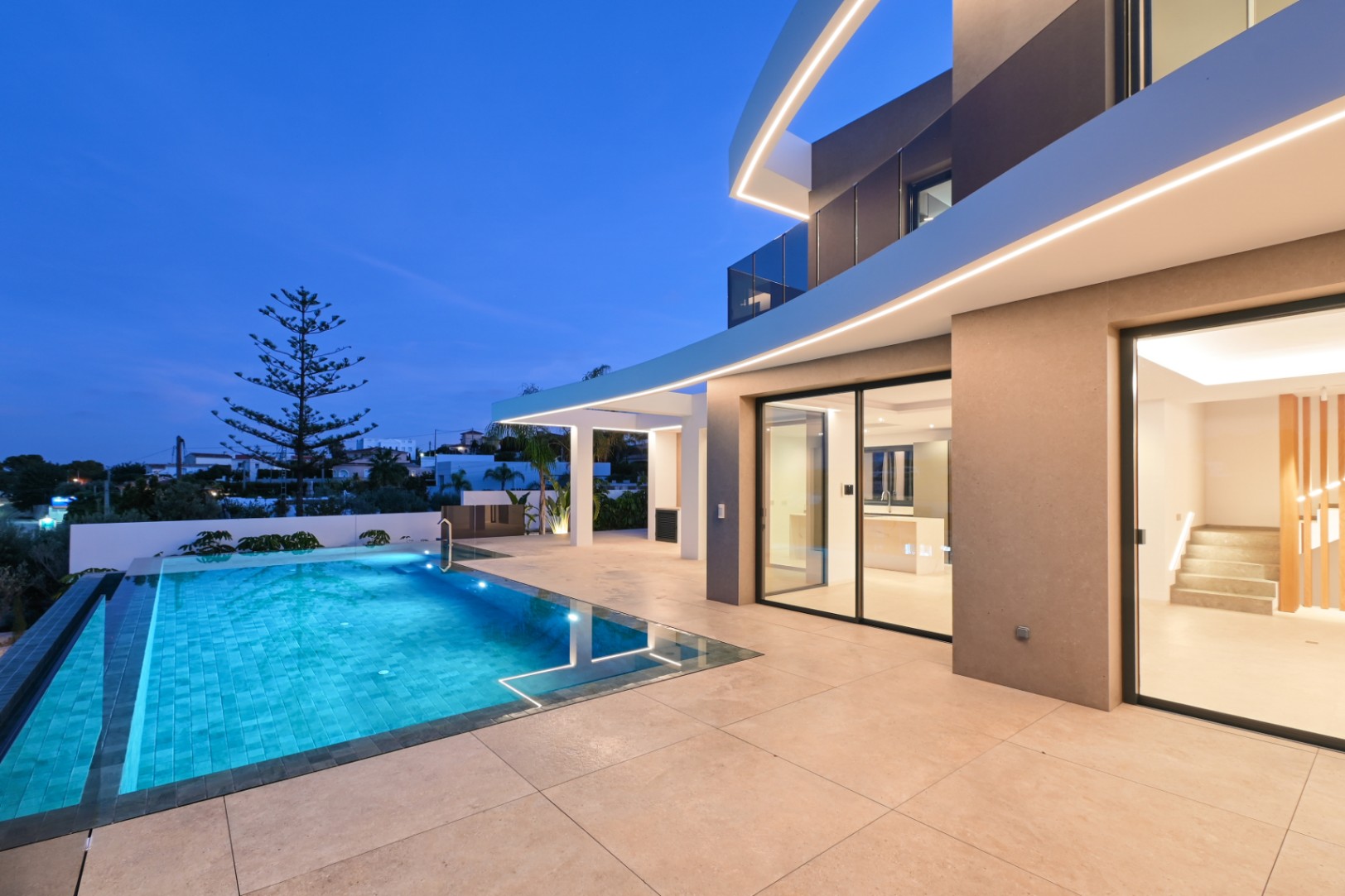 Infinity pool terrace at night at luxury villa near La Fustera Beach