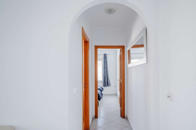 Interior hallway in a Calpe villa with arched ceiling detail and access to the bedroom areas