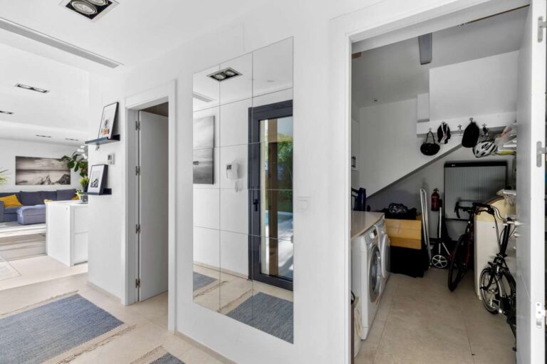 Interior hallway with access to laundry and storage areas inside a modern oasis villa for sale in Calpe.