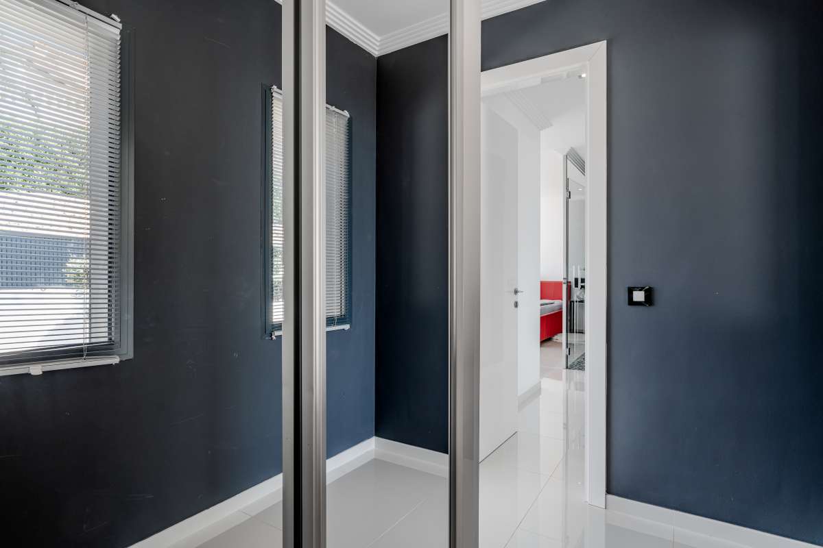 Interior hallway with contemporary finishes and dark accent walls inside a luxury villa in Gran Sol, Calpe.