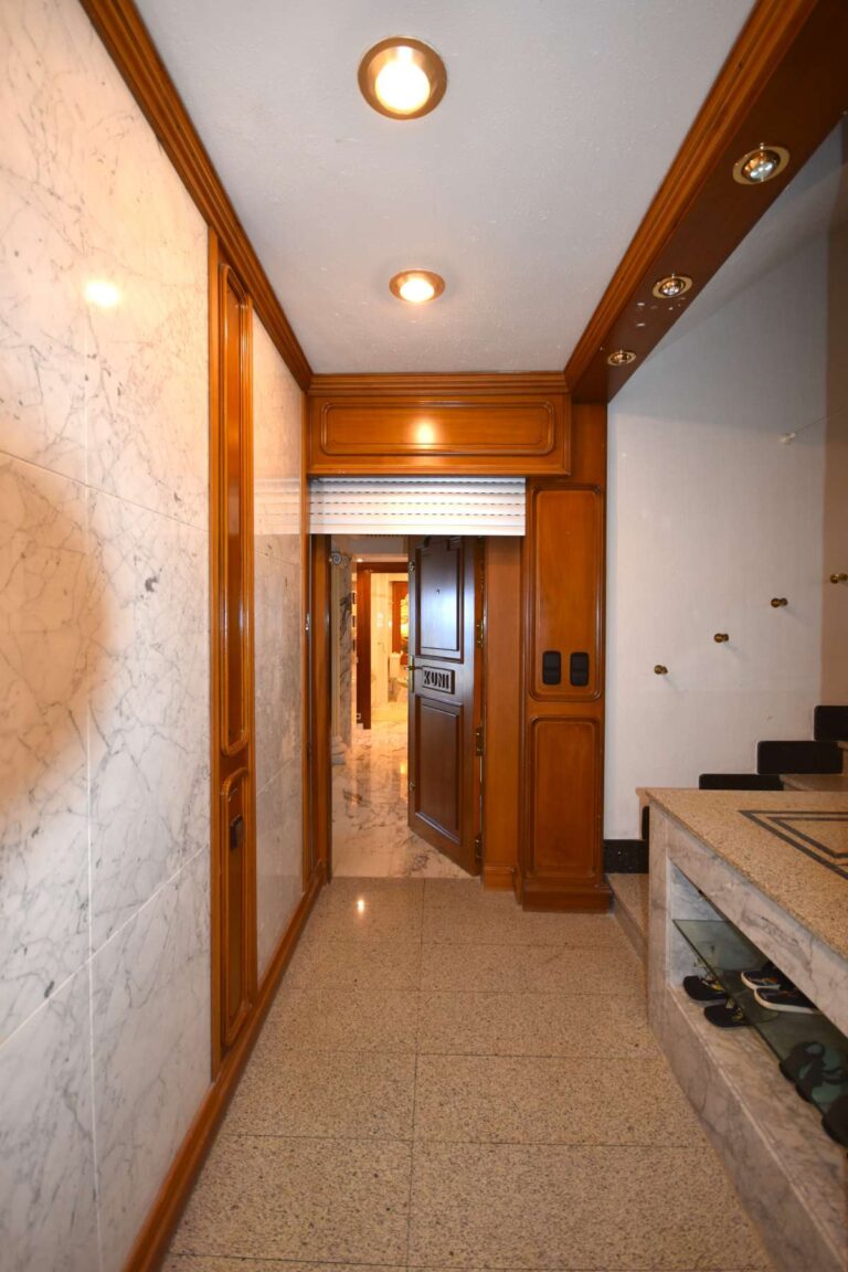 Interior hallway with quality finishes and wooden detailing inside a frontline double penthouse on Arenal Beach in Calpe.