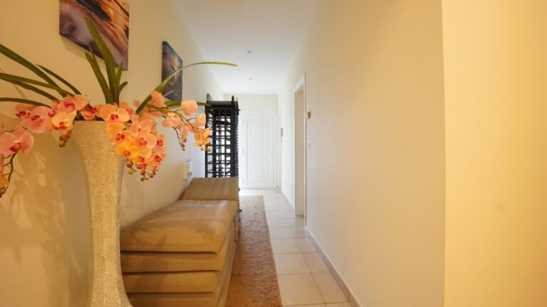 Interior hallway with staircase and natural light inside a villa in La Fustera near the sea.