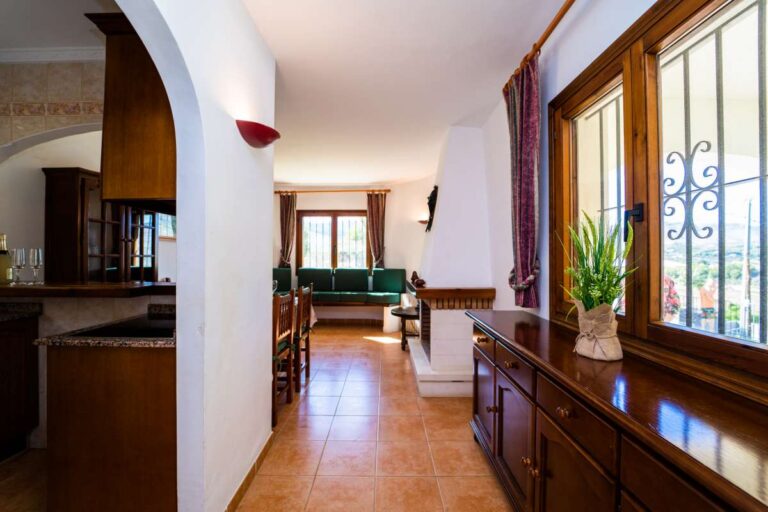 Interior hallway with traditional wooden furniture and natural light inside a Mediterranean villa in Cometa III, Calpe.