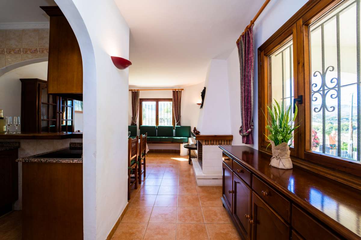 Interior hallway with traditional wooden furniture and natural light inside a Mediterranean villa in Cometa III, Calpe.
