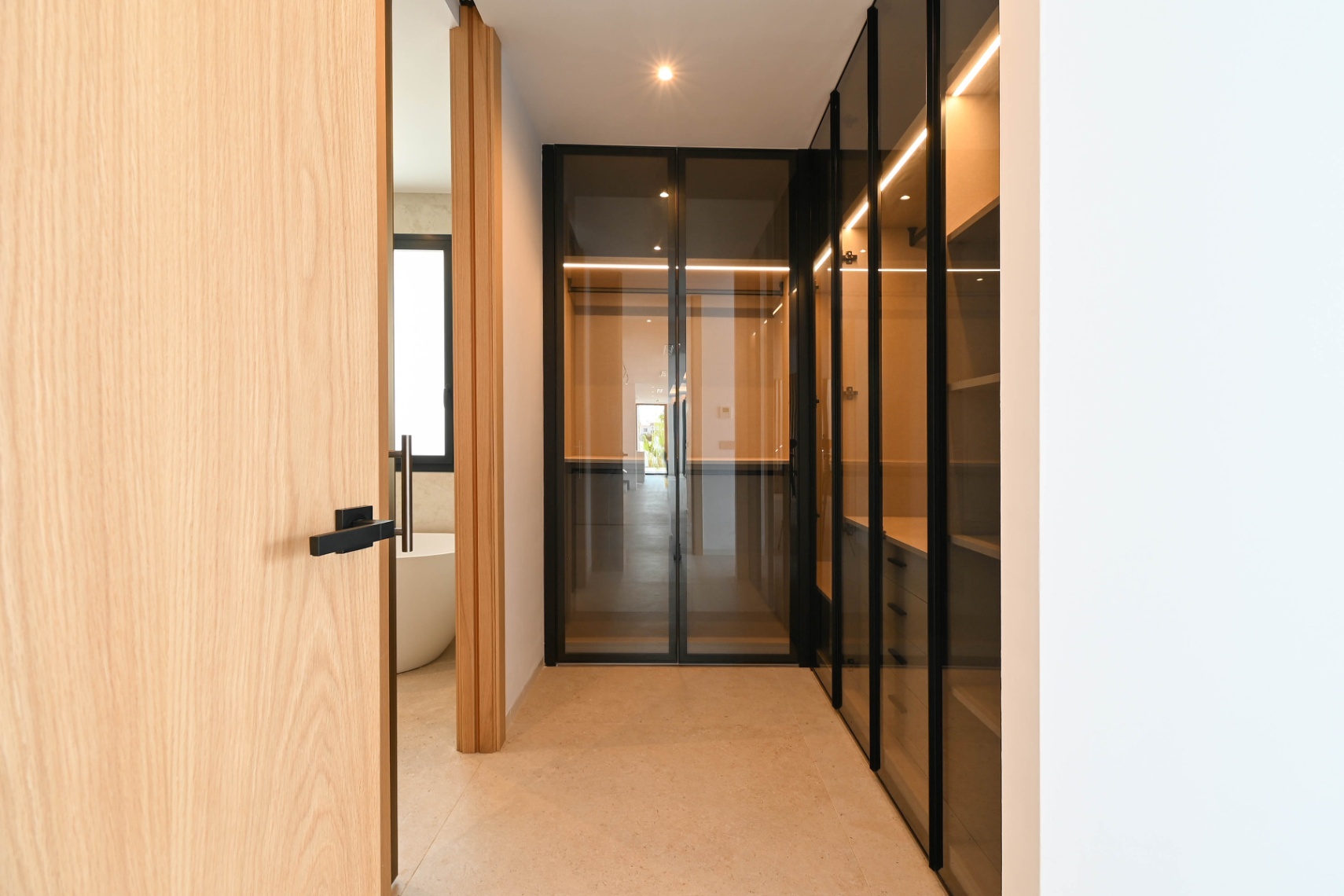 Interior hallway with wood and glass finishes at luxury villa near La Fustera Beach