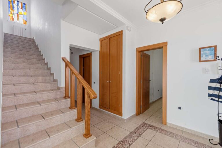 Interior staircase and hallway connecting the levels of a villa in Calpe.