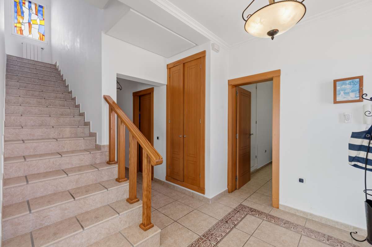 Interior staircase and hallway connecting the levels of a villa in Calpe.