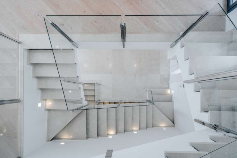 Interior staircase inside a modern villa in La Calalga, Calpe with glass balustrade, bright finish and contemporary architectural design