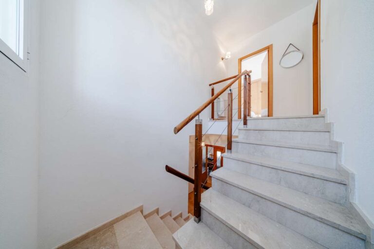 Interior staircase inside a semi-detached house in Calpe with bright hallway and access to upper floor bedrooms