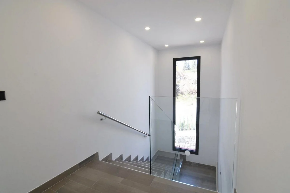 Interior staircase with glass balustrade in modern Calpe villa