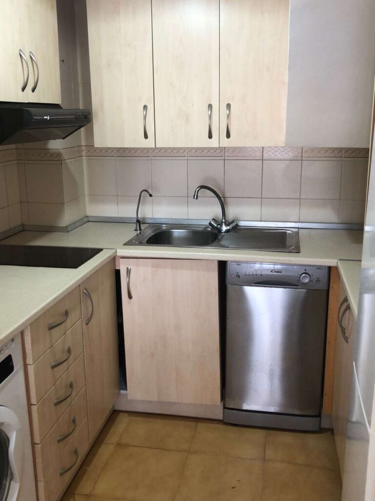 Kitchen inside a frontline townhouse in Calpe with fitted cabinets, sink, hob and dishwasher