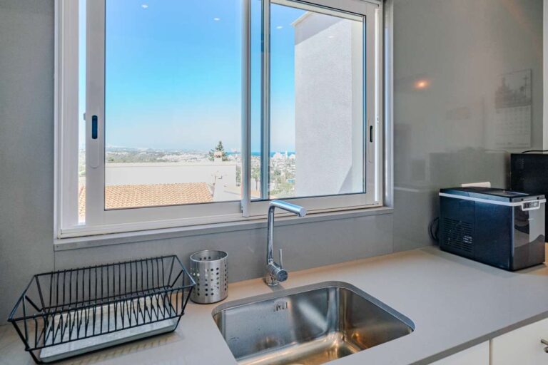 Kitchen inside a modern villa in Calpe with sink, window and views towards the sea