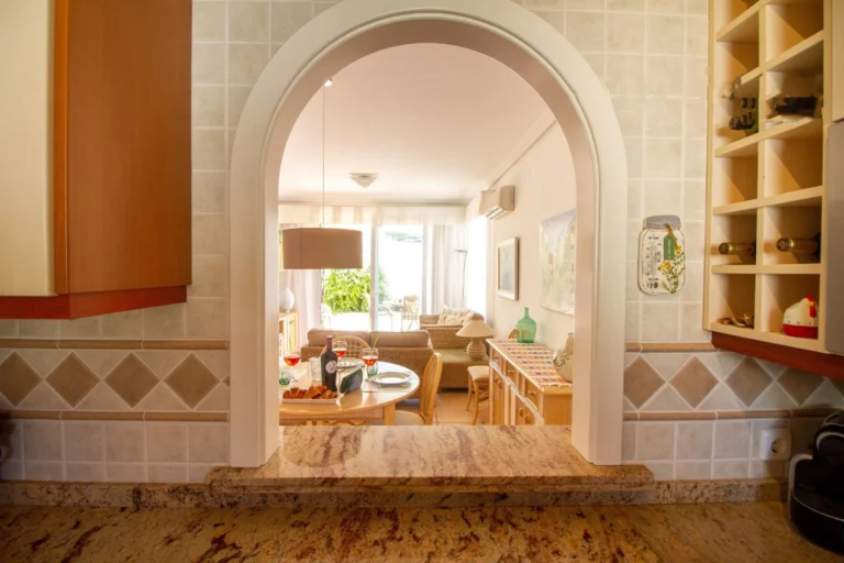 Kitchen view towards living room inside bungalow in La Vallesa Calpe