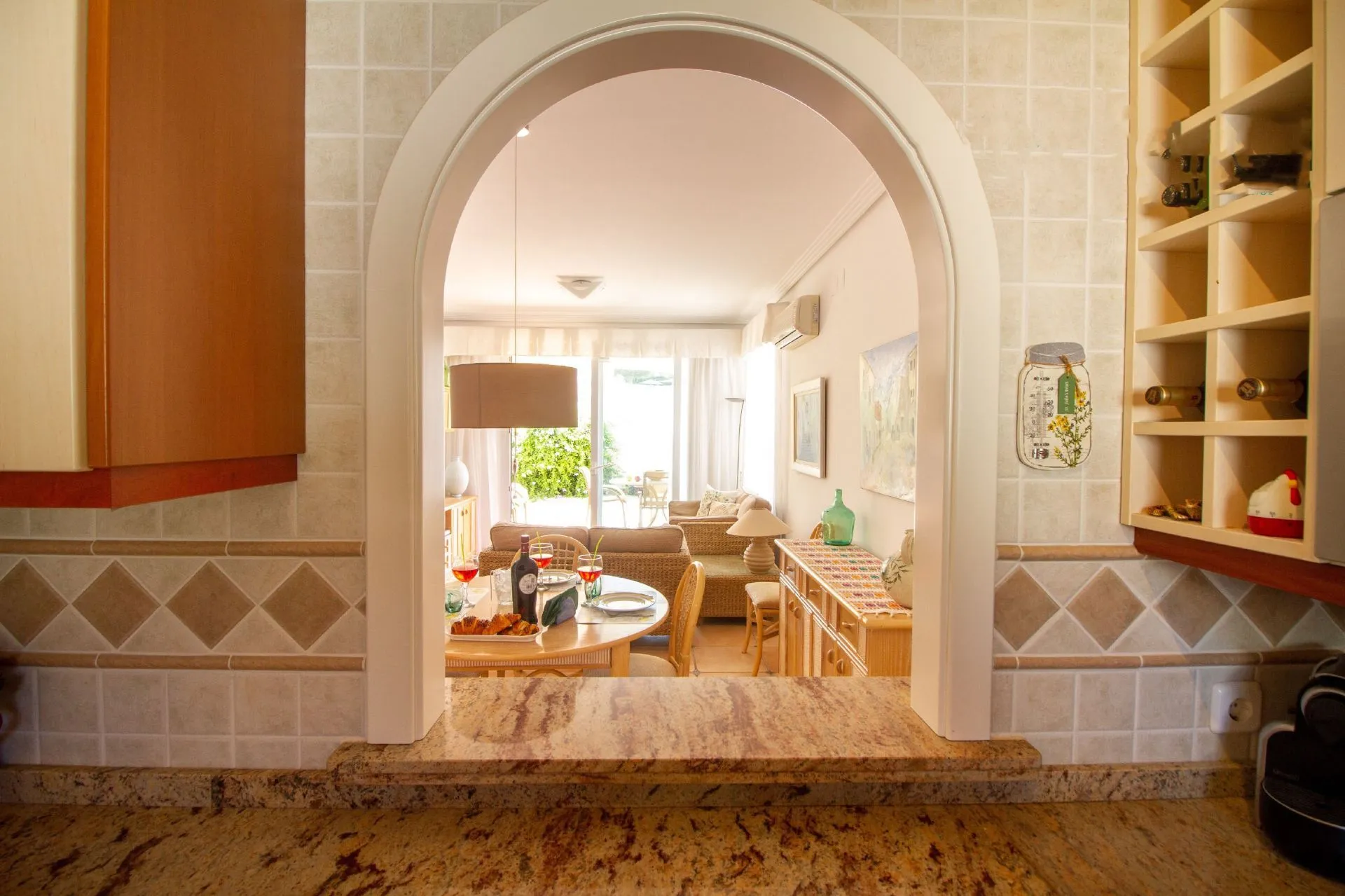 Kitchen view towards living room inside bungalow in La Vallesa Calpe