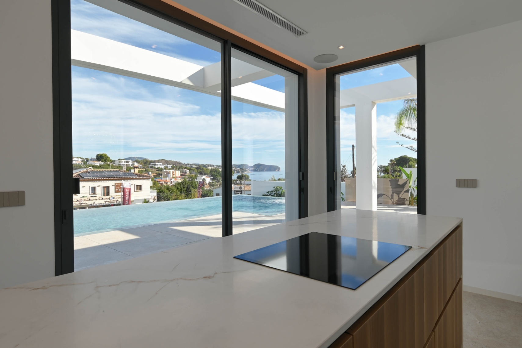 Kitchen with sea views and large glass doors at luxury villa in Benissa