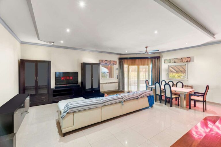 Large living and dining room inside a private villa in Calpe with spacious seating area, dining space and natural light
