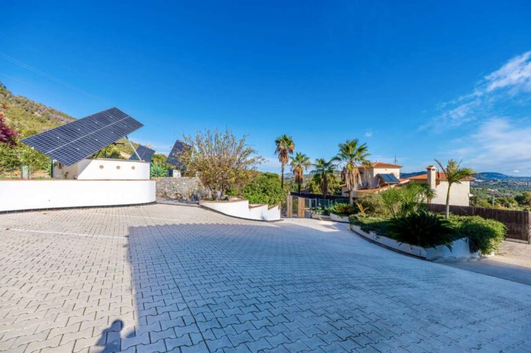 Large private parking area at a villa in Calpe with solar panels, open views and secure gated access