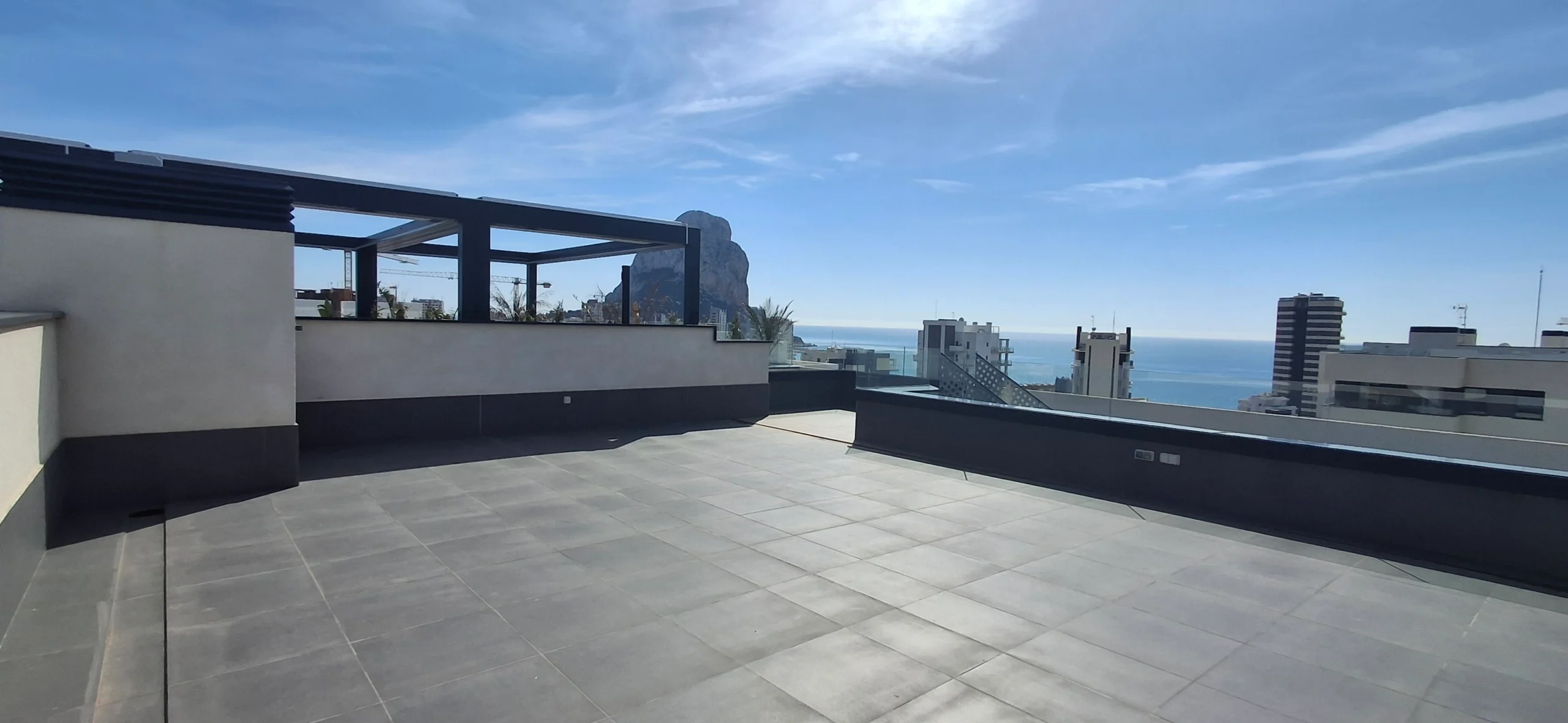 Large rooftop terrace with sea and mountain views at penthouse in Calpe`