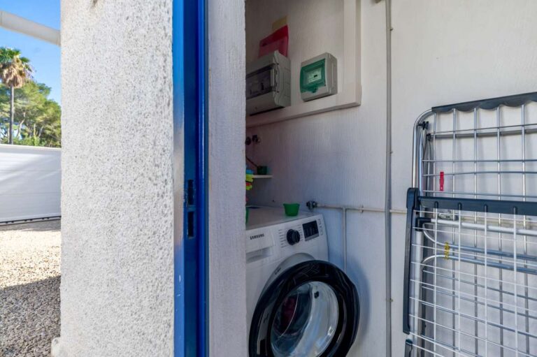 Laundry area with washing machine and utility space at a contemporary villa in Calpe.