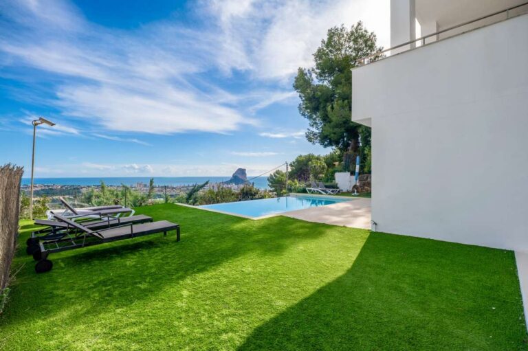 Lawn area with panoramic sea views and coastal outlook at a modern spacious villa in Calpe.
