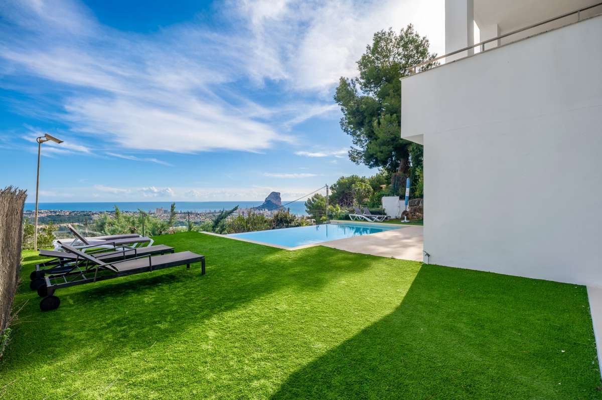 Lawn area with panoramic sea views and coastal outlook at a modern spacious villa in Calpe.