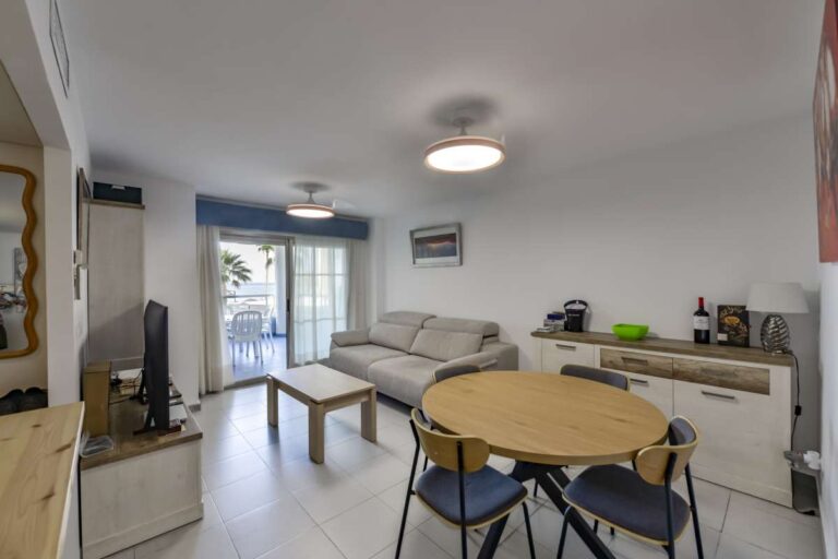 Living and dining area inside a beachfront apartment in La Fossa, Calpe with terrace access and natural light