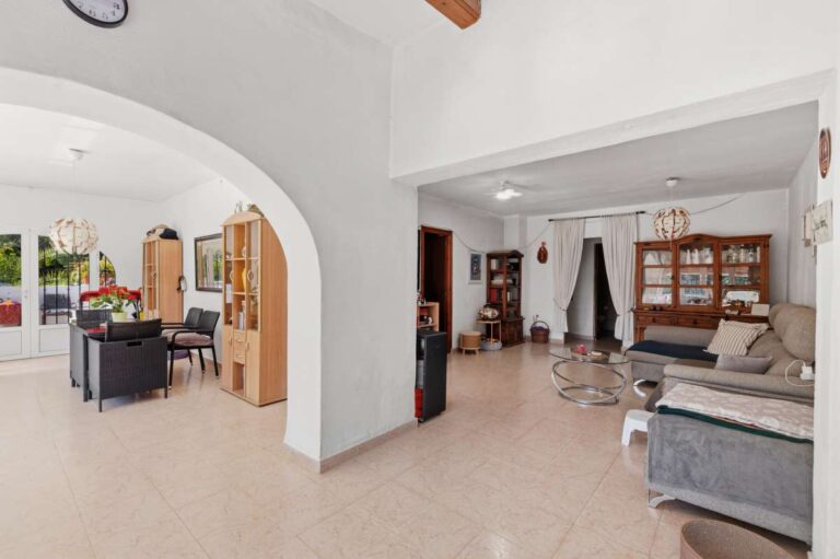 Living area inside a Mediterranean villa in Benissa Costa near Cala Baladrar with arched opening, sofa seating and bright interior finish