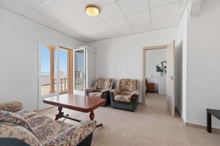 Living area with sofas, coffee table, and natural light inside a villa in Calpe.