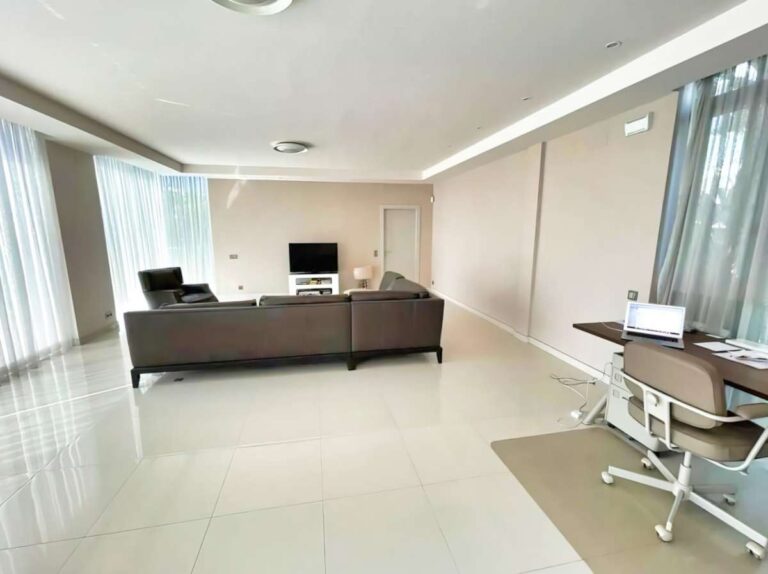 Living room inside a modern luxury villa in La Calalga, Calpe with sofa seating, office area, large windows and bright open layout
