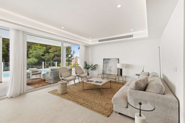 Living room inside a modern villa in Altea Hills with sofa seating, large windows, bright interiors and terrace access