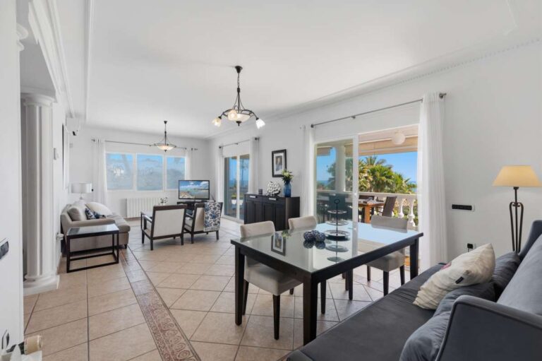 Living room with large windows and sea views inside a villa in Calpe.