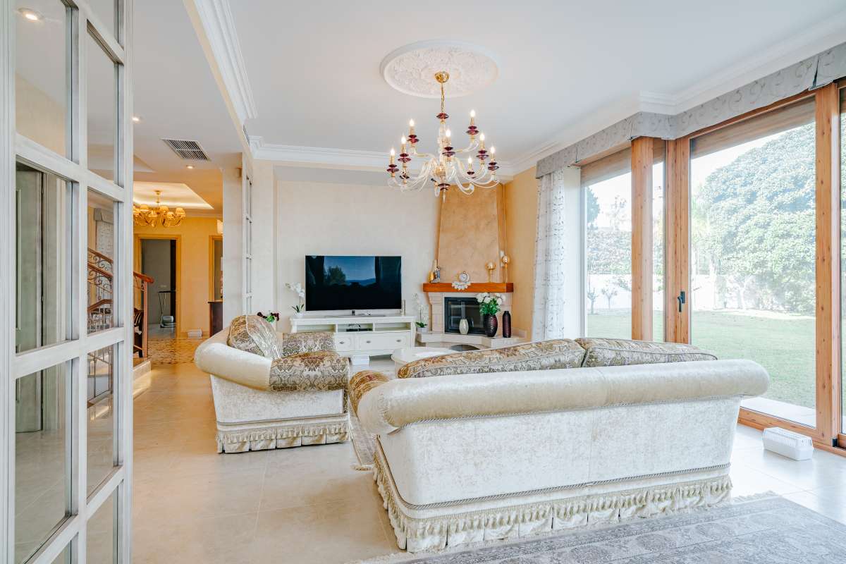 Living room with large windows, natural light and sea views inside a frontline villa in Les Bassetes, Benissa Coast.