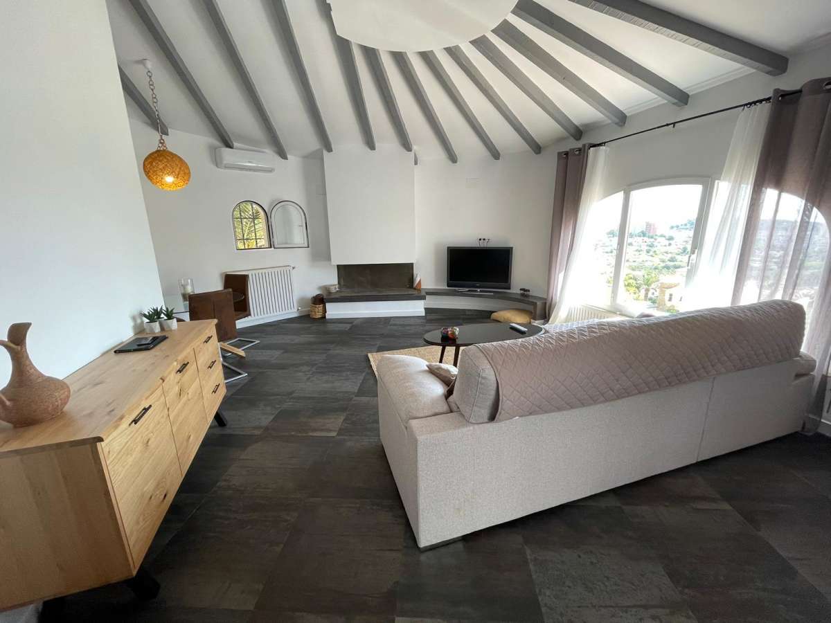 Living room with vaulted ceiling and natural light inside a refurbished villa with three independent apartments in Canuta, Calpe.