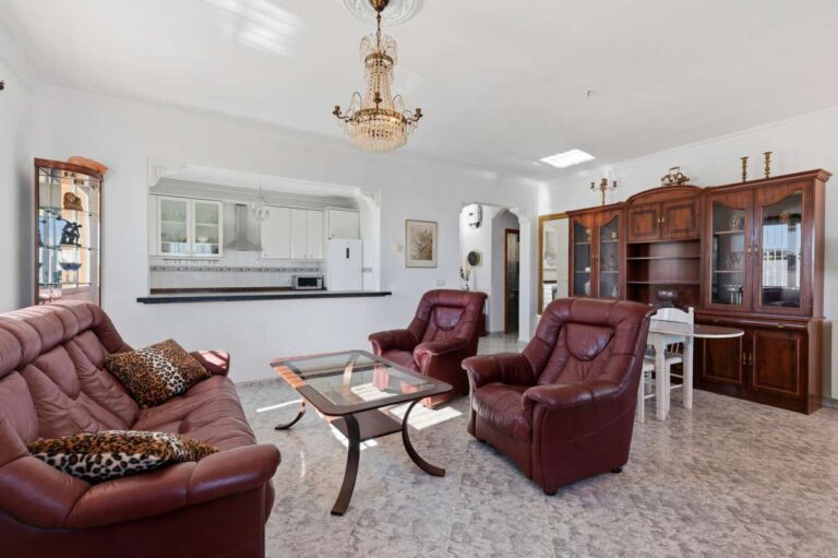 Lounge area with armchairs and natural light inside a villa in Calpe with Peñón de Ifach views.