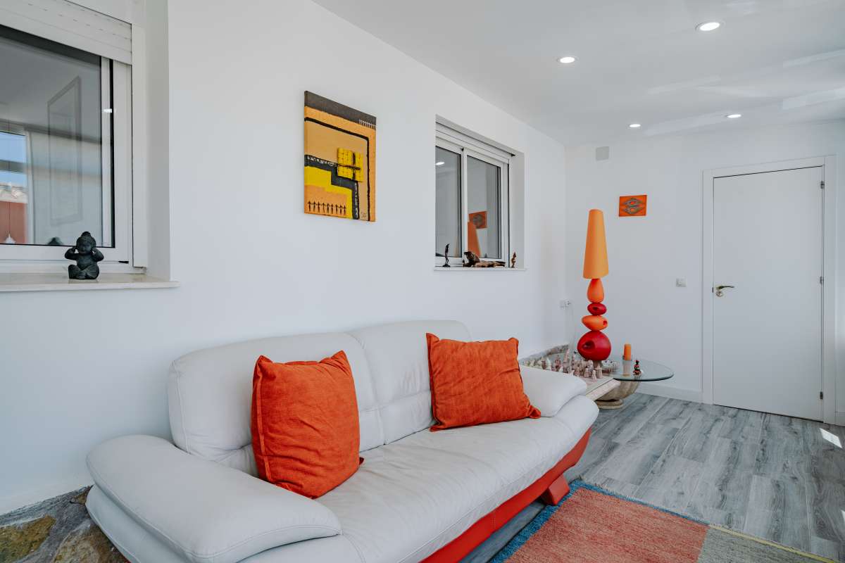 Lounge area with white sofa and light-toned interior inside a renovated Mediterranean villa in La Cometa, Calpe.