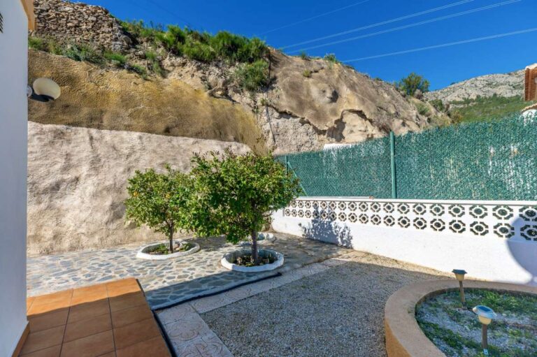 Low-maintenance garden area with gravel, plants, and surrounding mountain views at a villa in Calpe.