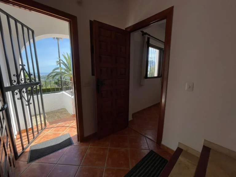 Lower-level entrance with terrace access and sea views at a villa in Calpe.