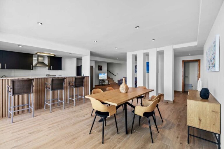 Lower level kitchen and dining area with breakfast bar inside a modern spacious villa in Calpe.