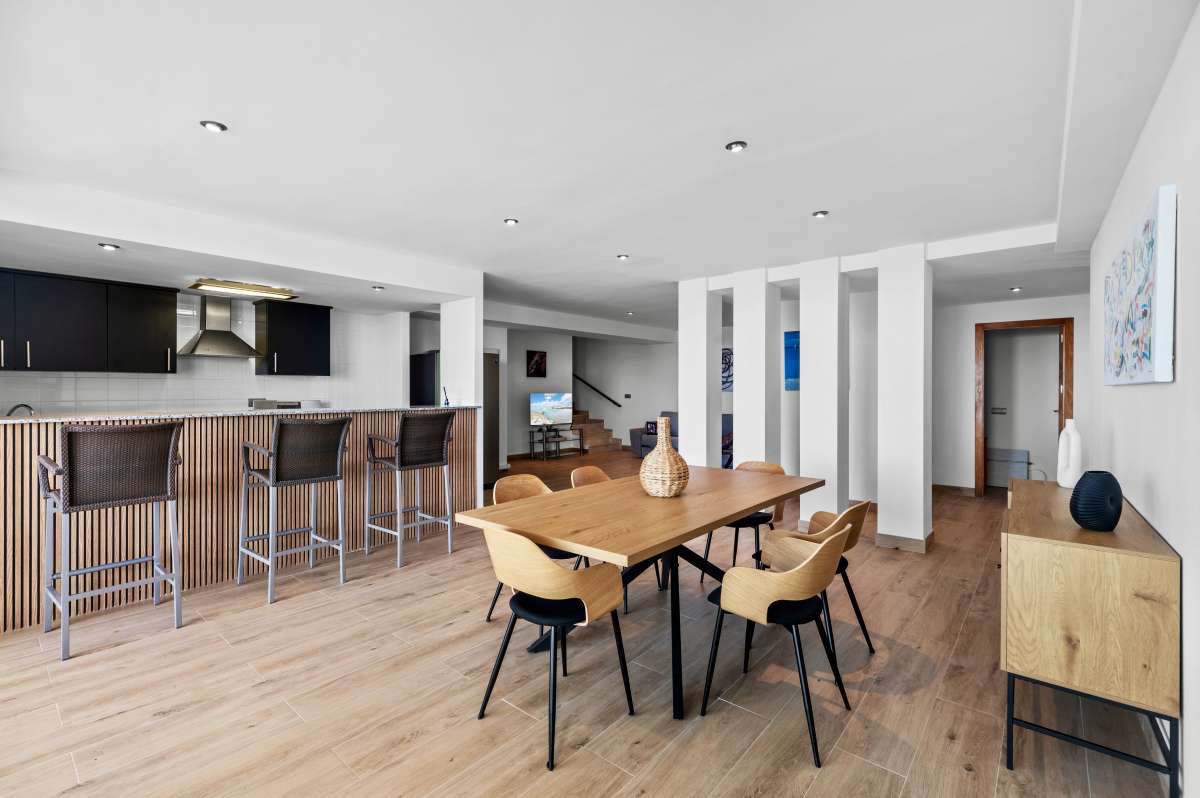Lower level kitchen and dining area with breakfast bar inside a modern spacious villa in Calpe.