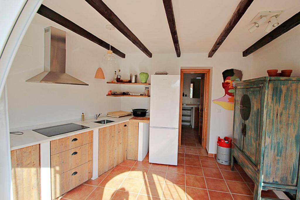 Lower-level kitchen with exposed ceiling beams at villa in Moraira