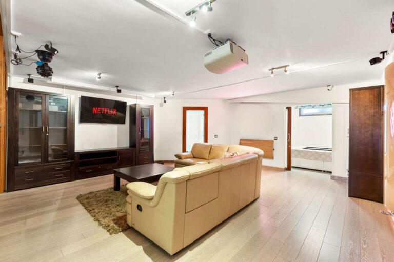 Lower-level living room inside a private villa in Calpe with sofa seating, TV area and independent living space