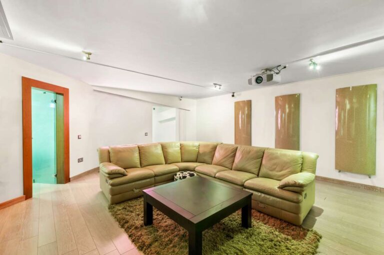 Lower-level lounge inside a private villa in Calpe with corner sofa, coffee table and independent living space