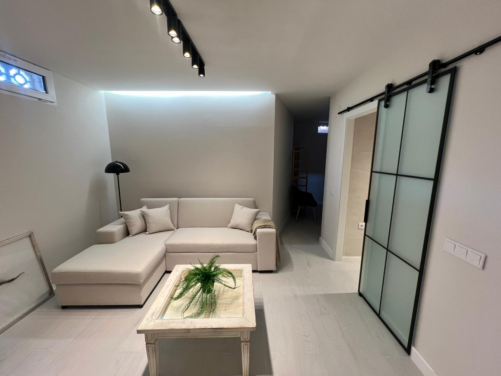 Lower level lounge with sliding doors at modern villa in Moraira