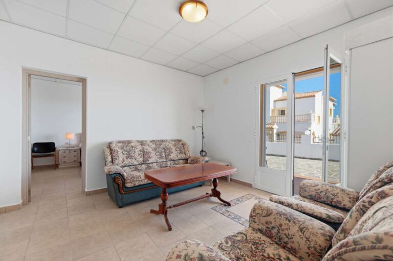 Lower living area with seating and natural light inside a villa in Calpe.