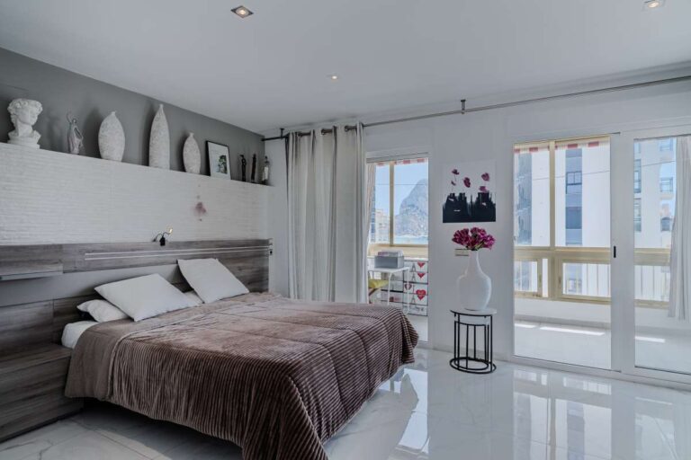Main bedroom inside a renovated apartment in Arenal-Bol, Calpe with sea views, terrace access and fitted storage