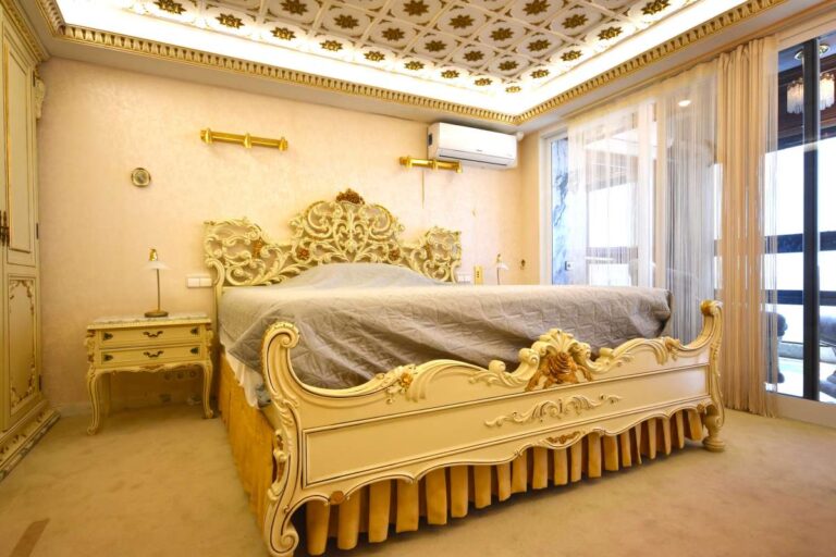Main bedroom with custom-made furniture, decorative ceiling and quality finishes inside a frontline double penthouse on Arenal Beach.