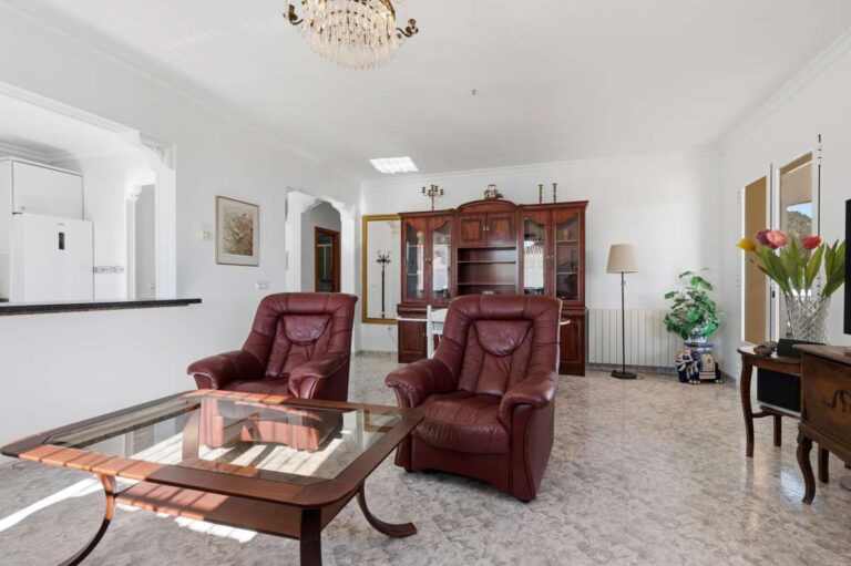 Main living space with seating area and large windows inside a villa in Calpe.