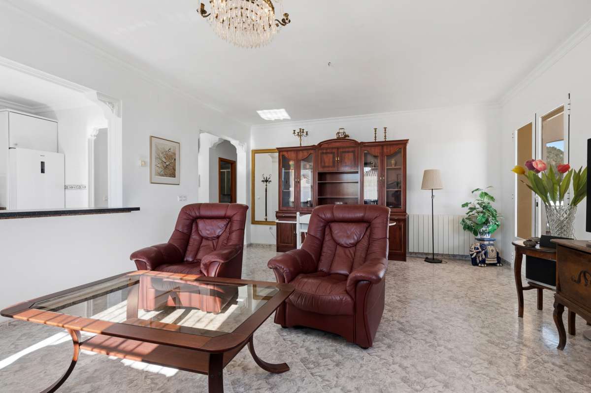 Main living space with seating area and large windows inside a villa in Calpe.