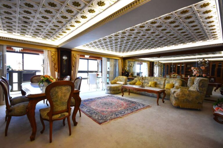 Main penthouse living space with dining area, custom-made furniture and large windows in a frontline property on Arenal Beach, Calpe.